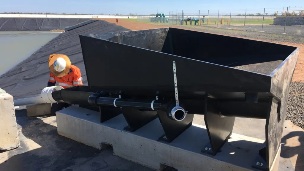 Mining equipment hopper and chute assembly in the field